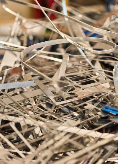 Piled metallic scraps and trimmings showcasing the industrial process and recycling potential.